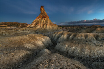 Castildetierra rock formation at sunset in Bardenas Reales desert landscape under dramatic sky