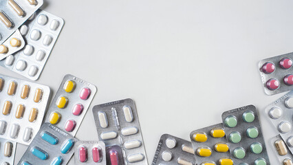 Blister packs with colorful pills framing copy space representing medication healthcare pharmaceutical advertising background
