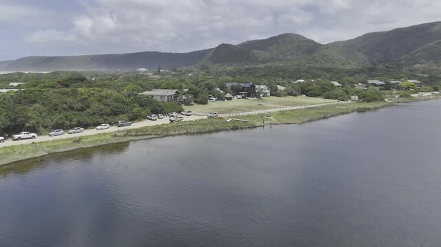 Drone flies west over Groot River on a sunny day in Nature's Valley, South Africa