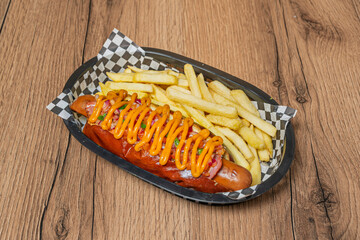 A close-up of a hot dog covered in spicy chili con carne, crushed nachos for crunch, pickled red...