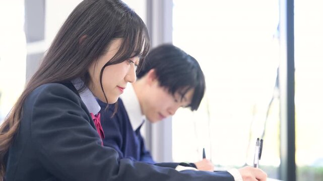 学校や塾などの教室で受験対策など勉強する男子高生と女子高生の動画　テストの模試や高校生の大学受験イメージ