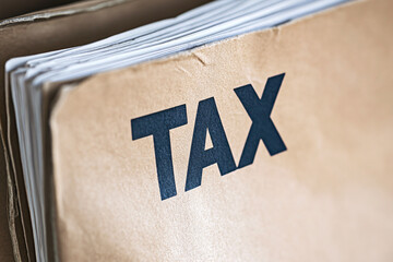 Close up of word 'Tax' on brown document file dossier