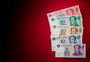 Chinese banknotes on a red background