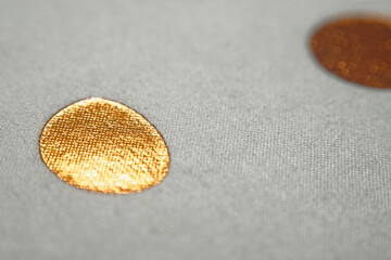 Macro of Golden Foil Dots on Grey Fabric