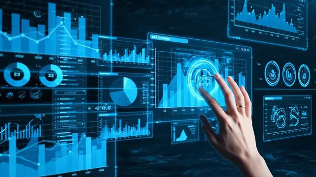 Close-up of a hand touching a glowing blue digital data interface with various charts and graphs.