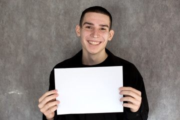 Young Man Holding Blank White Sign for Your Message