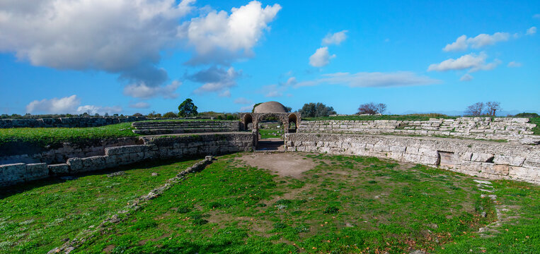 Ancient Roman amphitheater ruins in Paestum archaeological park, Italy.