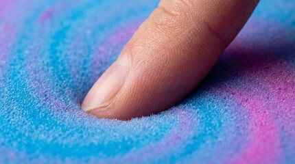 Macro shot of finger pressing into soft colorful memory foam