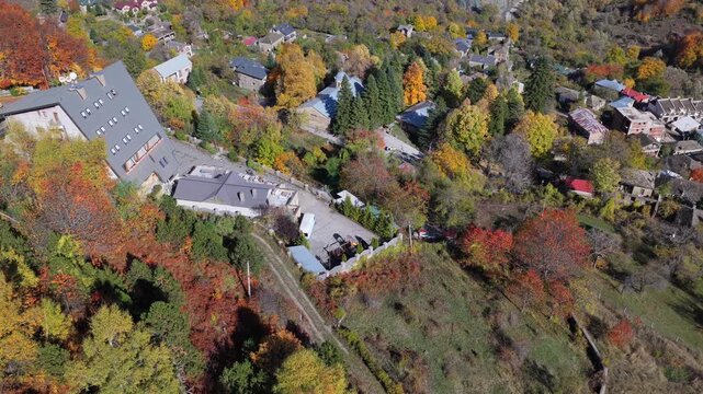 Aerial video of Dardh&euml;&rsquo;s autumn valley, with colorful forests, mountain slopes, and winding village roads under a bright sky.