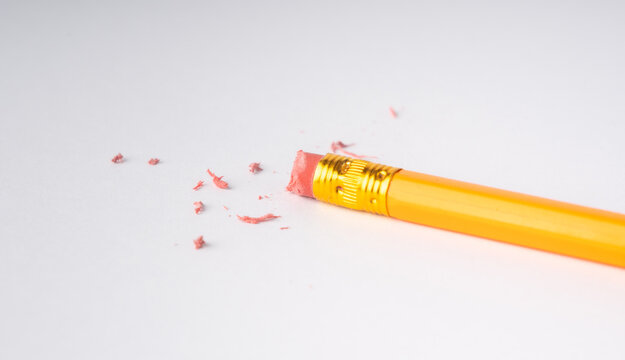 Eraser on paper. Erasing what was written, deleting an error, correcting mistake