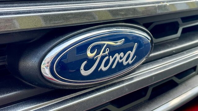 CHERKASY, UKRAINE - JUNE 20, 2025: A close up shot of the iconic Ford blue oval logo on a car's front radiator grille.