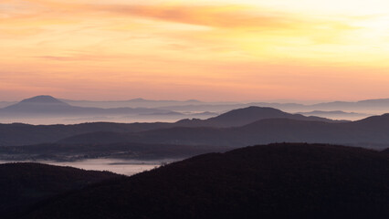 Gradina viewpoint at mountain Zlatibor offering beautiful view of hilly rural landscape and valleys filled with fog at dawn, visit Serbia countryside, autumn season at October