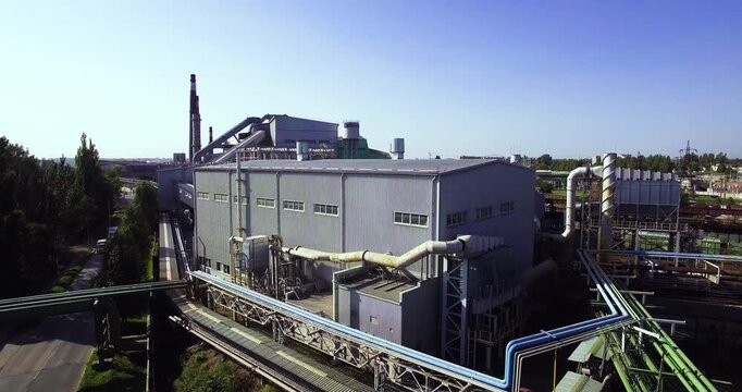 View of a large industrial plant and the surrounding area. Zoom out.