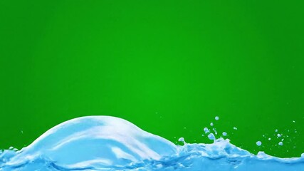Vibrant splashes of blue liquid against green backdrop - Powered by Adobe