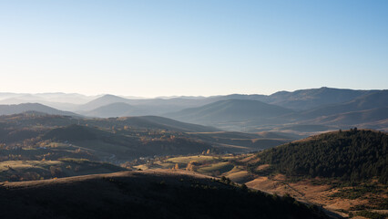 Gradina viewpoint at mountain Zlatibor offering beautiful view of hilly rural landscape with morning haze, visit Serbia countryside, autumn season at October