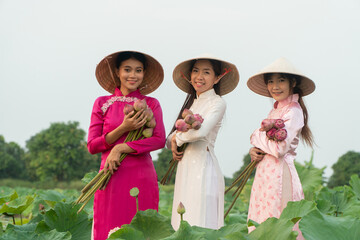 Harmony of Cultures: Three figures adorned in traditional attire, hold lotus blossoms, their faces radiating smiles, surrounded by a serene environment.