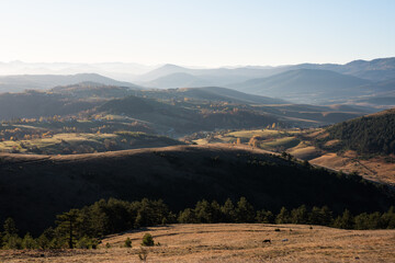 Gradina viewpoint at mountain Zlatibor offering beautiful view of hilly rural landscape with morning haze, visit Serbia countryside, autumn season at October