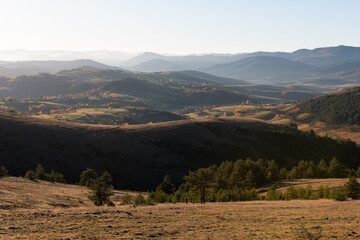 Gradina viewpoint at mountain Zlatibor offering beautiful view of hilly rural landscape with morning haze, visit Serbia countryside, autumn season at October