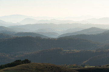 Gradina viewpoint at mountain Zlatibor offering beautiful view of rural landscape with hill layers fading in morning haze, visit Serbia countryside, autumn season at October