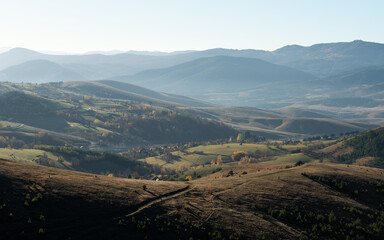 Gradina viewpoint at mountain Zlatibor offering beautiful view of hilly rural landscape with morning haze, visit Serbia countryside, autumn season at October