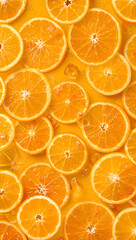 Bright and colorful image of fresh orange slices with seeds floating in a vibrant yellow liquid, perfect for food and beverage concepts.
