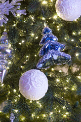 Christmas toys and luminous garlands on the tree