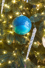 Christmas toys and luminous garlands on the tree