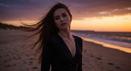 Woman stands beachside; sunset glow