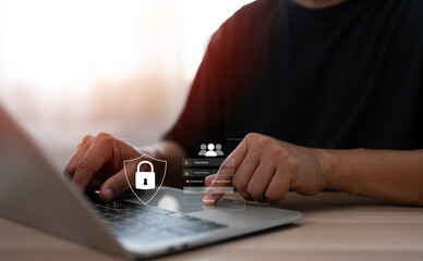 Hand of a man using mobile phone and laptop, secure access to user personal information, secure Internet access, information security encryption. Cybersecurity internet network data privacy concepts.