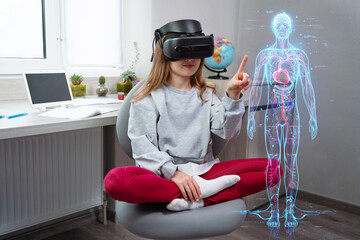 Schoolgirl is using virtual reality simulator headset for study. Child wearing virtual reality glasses studies human anatomy. Future learning concept