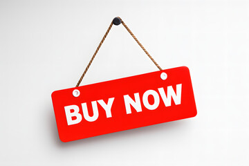 Red buy now sign hanging on a white wall, indicating a call to action for immediate purchase.