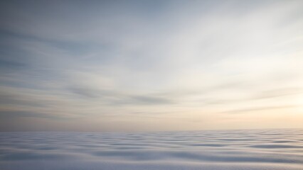Serene ocean surface at sunset with soft ripples and cloudy sky