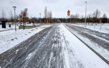 Winter urban park road with traffic signs and speed limit in Opole