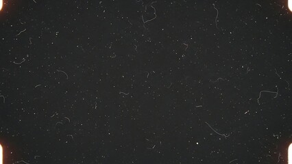 Black background with white speckles texture.