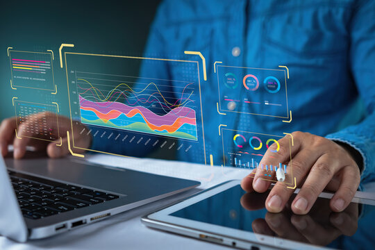 Businessman using tablet to analyze financial datum report with virtual dashboard charts. Concept for business data analytics, digital technology, and global market growth strategy. - Powered by Adobe