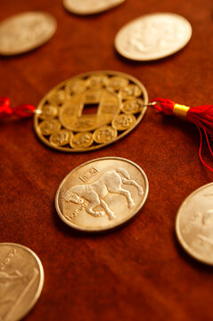 lucky china  zodiac and the coin of horse lying on wooden background, chinese astrology new year, year of horse 2026, 