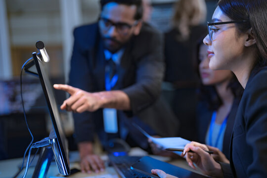 A team of financial analysts works through the night in a fast-paced firm, processing market data, reviewing performance reports, and executing trades to manage investment portfolios. - Powered by Adobe