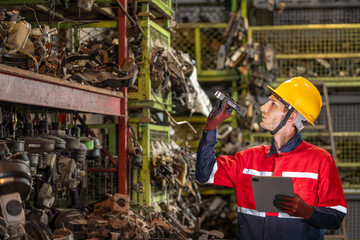 technician finding searching car old Auto parts in warehouse by tablet technology mechanic...
