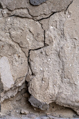 Cracked surface on a wall showing signs of wear and age in an urban environment during daylight
