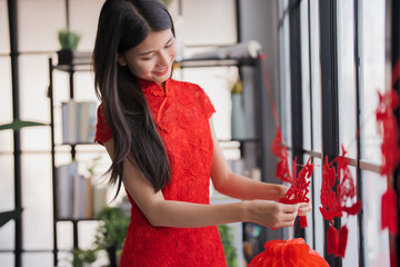 Beautiful young asian woman&nbsp;red clothes making paper craft red Chinese new year lantern for Lunar New Year decorations Chinese New Year Celebrations for good luck