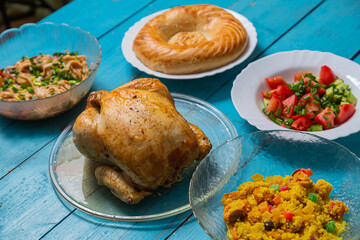 Couscous with dried fruits and turmeric, baked whole chicken, flatbread