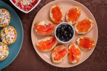 Chicken salad, salad in tartlets, canap s with red caviar, trout, and olives