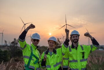 Engineers working on site in wind turbine farm at sunset, Wind turbines generate clean energy source, Eco technology for electric, industry environment.