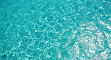 Obraz premium Crystal Clear Turquoise Waters Reflecting Sunlight: A Serene Ocean Surface Texture for Backgrounds and Overlays