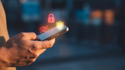 Person holds smartphone with digital security icons, including lock and shield, symbolizing privacy and protection. image conveys sense of security and technology