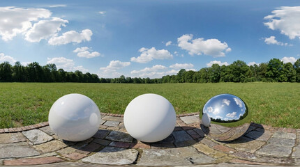 Three Spheres on Cobblestone Path in Grassy Field with Cloudy Blue Sky Panorama environment