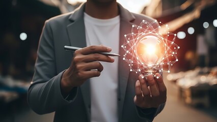 Person in a suit holding a pen points towards a glowing digital light bulb connected by a network of lines.