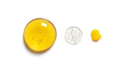 Fototapeta premium A close-up view of a yellow substance and two small containers on a white surface with a coin for scale