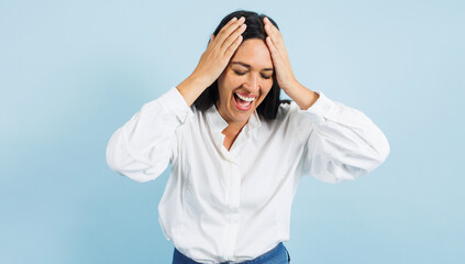 portrait of adult mexican woman surprised on blue background in Mexico Latin America, or Latina middle aged brunette shocked female
