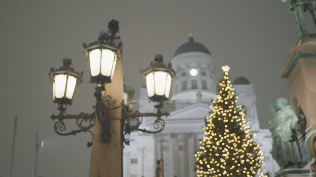 A charming city square adorned with festive Christmas lights and decorations, featuring a beautifully lit tree, lanterns lining the street, and a backdrop of historic architecture, creating a warm hol